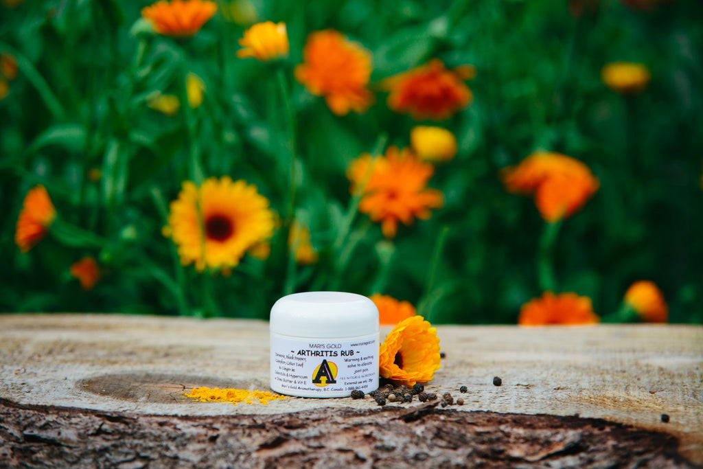 Best Natural Arthritis Rub in white container with calendula flowers